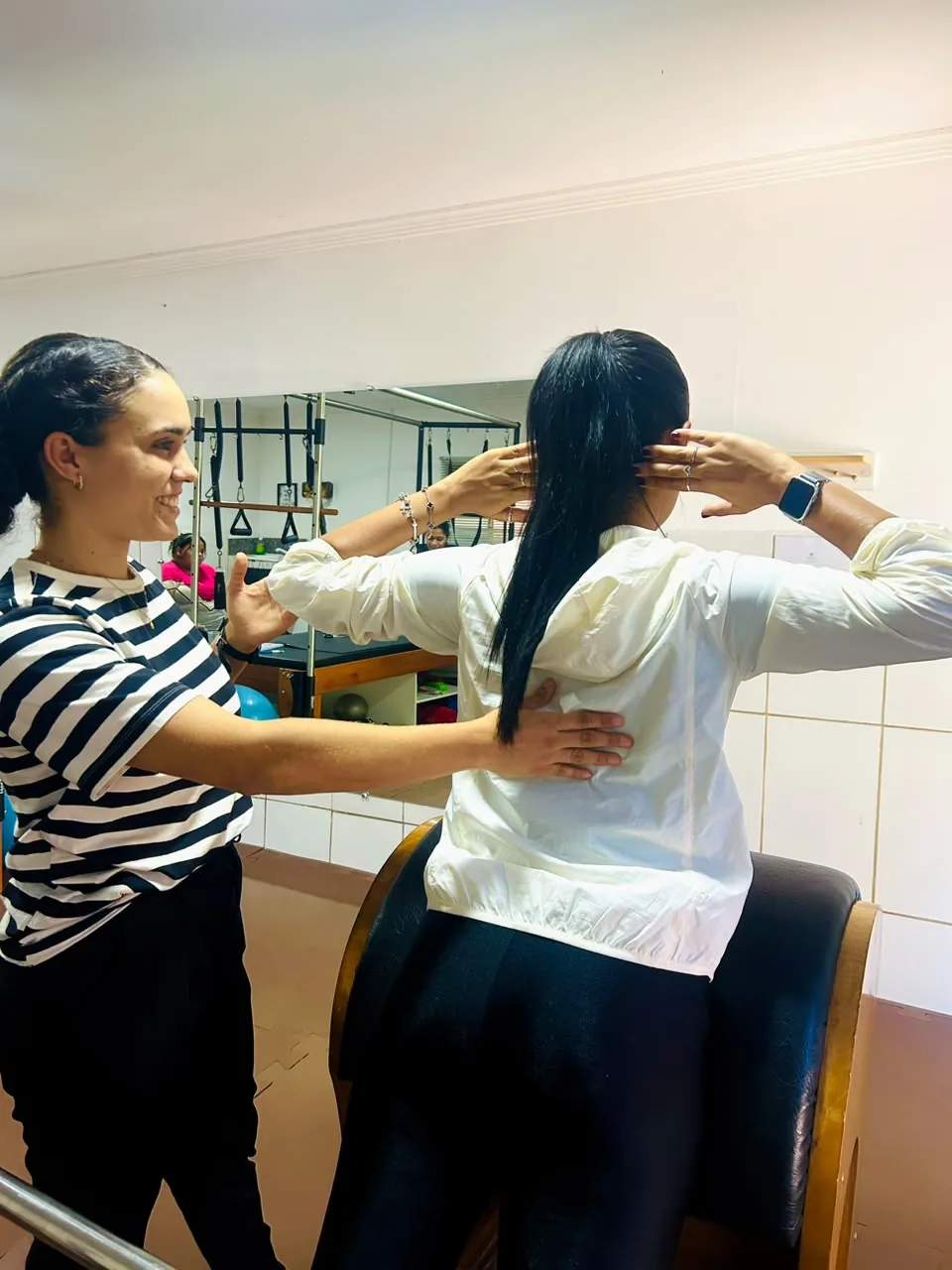 Leticia orientando o posicionamento de uma pessoa durante uma atividade no estúdio.